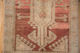 Machine-bound edge and distressed barber pole border on the vintage Oushak rug.