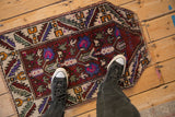 Overhead view showing the scale of a vintage Oushak rug with a tree of life design on a floor.