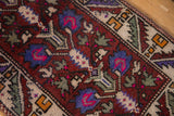 Close-up of the vintage Oushak's short pile, with rich magenta, blue, and saffron yellow details.