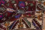 Folded corner of a vintage Turkish Oushak rug showing the dense, short pile and colorful geometric details.