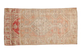 Distressed Oushak rug runner with a faded hexagonal medallion in soft melon blush, cherry red, and ivory.