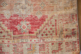 Exposed knot heads and abraded pile of a vintage Oushak rug with cherry red geometric motifs.