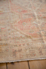 Detailed view of the distressed, low-pile texture on a vintage Oushak rug runner.