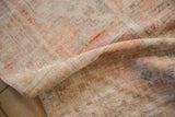 Close view of the worn, low pile and hand-knotted texture on a distressed Oushak rug.