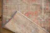 The hand-knotted reverse and secure machine-bound edge of a distressed vintage Oushak rug.