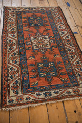 Sapphire blue geometric patterns on terracotta field with beige palmette border.