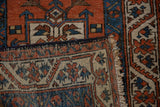 Folded vintage Karaja rug showcasing terracotta pile, contrasting woven reverse side, and fringe.