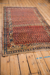 Abrashes, botehs, and sapphire border on this antique Kurdish Hamadan rug.