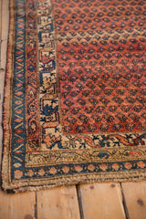 Secured fringed edge with sapphire blue and ivory borders, detailed geometric motifs.