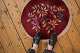 A small vintage Art Deco round mat shown at a person's feet for scale.