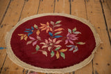 Angled view of the vintage Art Deco round rug mat, showing the full floral pattern and natural side cord edge.