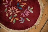Angled detail of the Art Deco rug's floral pattern and hand-secured side cord selvage.