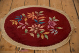 Angled view of the round Art Deco rug mat showing its complete floral design and ivory border.