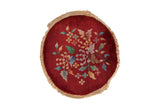 Vintage Art Deco round rug mat featuring a central floral bouquet on a rich burgundy red ground.