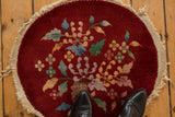A vintage Art Deco rug showing the hand-knotted texture and wear down to the foundation.
