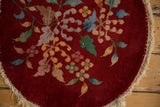 Detail of worn pile and exposed foundation next to the round rug's finished edge.