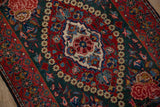 Serrated shield-like medallion in cherry red and ivory on a vintage Kashan rug.