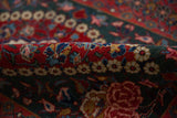 Texture of the hand-knotted pile on the cherry red and navy floral border.