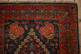 Detailed corner spandrel with a rose design and floral main border on a vintage Kashan rug.