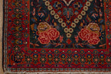 Rose spandrel corner design and floral border of a vintage Persian Kashan rug.