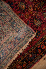 A corner folded back reveals the hand-knotted foundation and selvage of a fine Persian Lilihan rug.