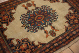 Angled view of a Farahan Sarouk rug's low pile, starburst medallion, and perched birds.