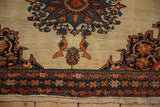 Two tangerine birds flank a colorful tree motif on the ivory field of a Farahan Sarouk saddle bag.