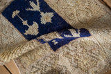 A folded view of the distressed Tulu rug showing its plush, shaggy pile.