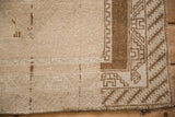 Corner detail of a vintage Malatya rug showing the low, worn pile and geometric border.