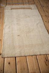 Reverse side of a distressed Malatya rug showing the hand-knotted foundation and side cord.