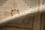 Soft, distressed pile of a vintage Oushak rug, highlighting even wear and pale ivory, rose, and green colors.