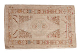 Vintage Distressed Oushak rug with faded beige field, central medallion, and geometric corner blossoms, 2'5