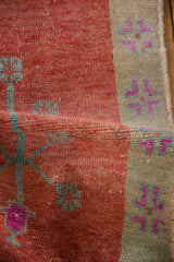 The soft, pliable texture and worn knot heads of a distressed vintage Turkish rug.