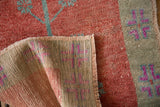 Hand-knotted back and secured side selvage of a distressed vintage Turkish Oushak rug.