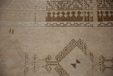 Reciprocating pawn design motif and even wear to the knot heads on a distressed vintage rug.
