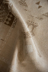 Softly folded vintage Malatya rug showing an even, low pile texture.