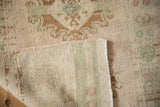Hand-knotted foundation and even, low pile of a distressed vintage Turkish Oushak rug.