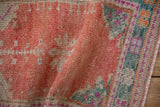 Softly worn hand-knotted pile of a vintage Turkish Oushak in cantaloupe and teal.