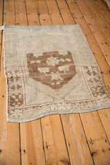 Vintage distressed Oushak rug with a bold, primitive medallion and naturally uneven contour.