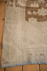 Texture of the evenly worn pile and intact side selvage on a vintage Oushak rug corner.