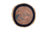 Antique Art Deco round rug with two butterflies, a brown field, and a wide navy blue border.