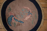 Detail of an Art Deco rug's short pile showing blush, blue butterfly motifs, and a navy border.