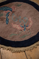 Hand-knotted Art Deco butterflies with blush and blue wings on a pale coffee brown field.