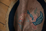 Hand-knotted texture and short pile of a folded antique Art Deco rug.