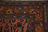 A vintage Mehrivan rug corner showing the meandering vine main border and reciprocating boteh design.
