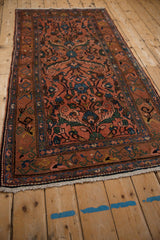The low pile and intricate borders of a vintage Mehrivan rug seen from a corner perspective.