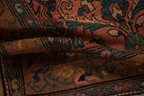 Low, hand-knotted pile and floral arabesque border of a vintage Mehrivan rug in dusty rose.