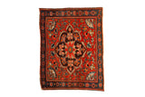 Antique Farahan Sarouk rug with a scalloped medallion, red floral field, and a dark sapphire blue main border.