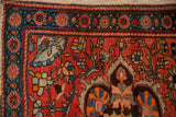 Hand-knotted floral motifs in the sapphire blue border of a collector's antique Sarouk rug.
