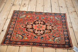 Antique Farahan Sarouk mat displaying its full scalloped medallion and floral design.